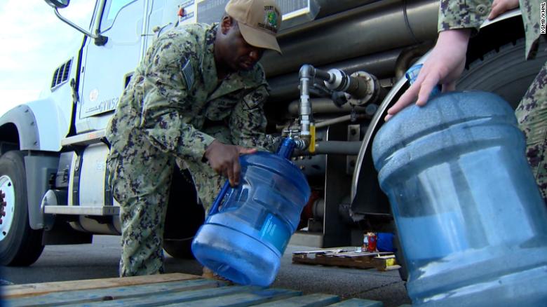 US Navy service members fill potable water for residents at the Navy Exchange Mall.
December 7 2021