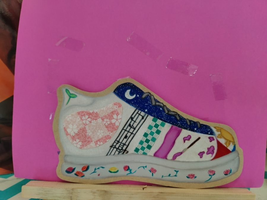 Amanda Ibanez represented her Filipino heritage and interest in Japanese culture in this shoe design. She incorporated symbols important to her, such as music and art. As a self-professed night owl, she included a nightscape at the top.