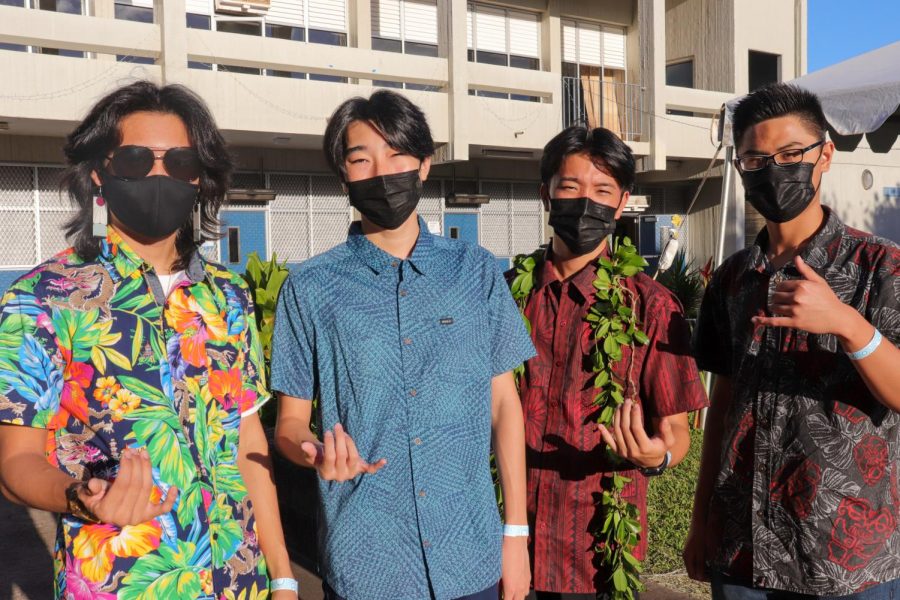 Ayden Correa, Ian Kozuki, Cadence Sasano, and Caleb Tiqui (left to right) toss up a shaka at senior luau.