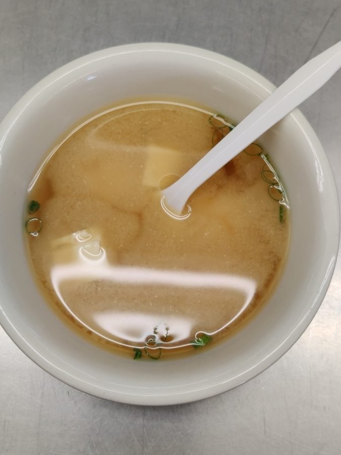 Miso soup with soft tofu cubes.