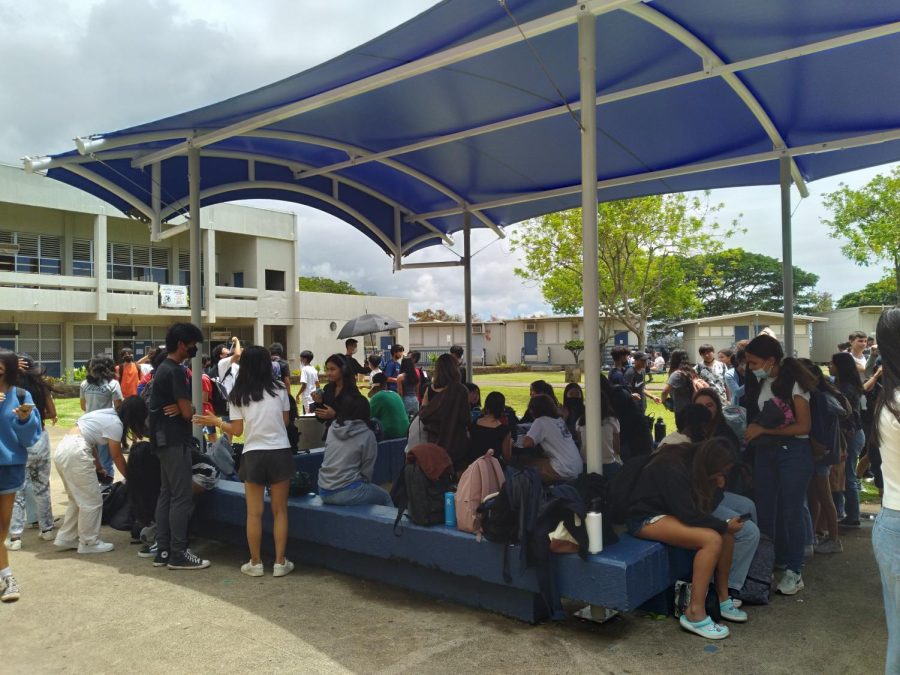Students sitting under the tent at lunch