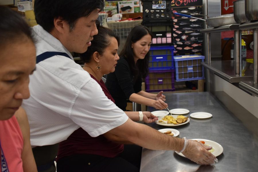 Culinary teacher Lars Mitsuda serves office staff Jonelle Titcomb (center) and Jill Kamimura-Salcedo their hot entree. Culinary 2 students practiced cooking and serving brunch this Thursday and Friday.  The meal included three entrees and a dessert, using local ingredients as much as possible.