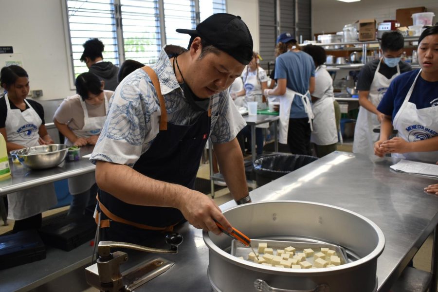 Mitsuda takes the temperature of the tofu cubes using a digital thermometer.