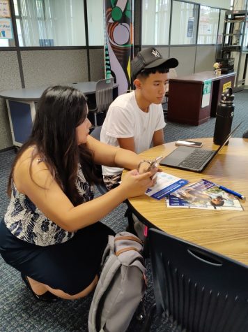 Chaminade Universitys Abigail Hurgo, assistant vice presdient for enrollment management, works with senior Ezekiel Villegas during this weeks College Application Week event in the library.