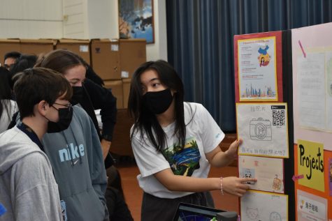 Sophia Rose (11) points out some of the projects the world language students do.