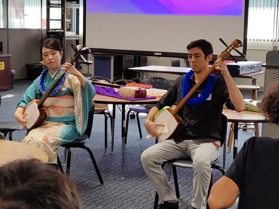 Anju (left) and Jerald James, a Moanalua High School class of 2010 graduate, performed two songs for the Japanese I students in the library on Tuesday. 