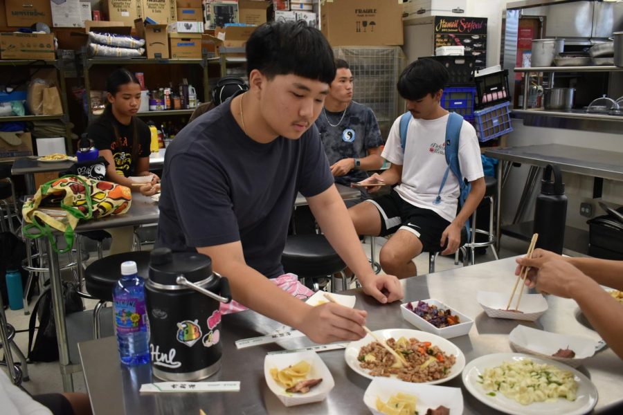 Davin Shin samples the dishes at the end of class.