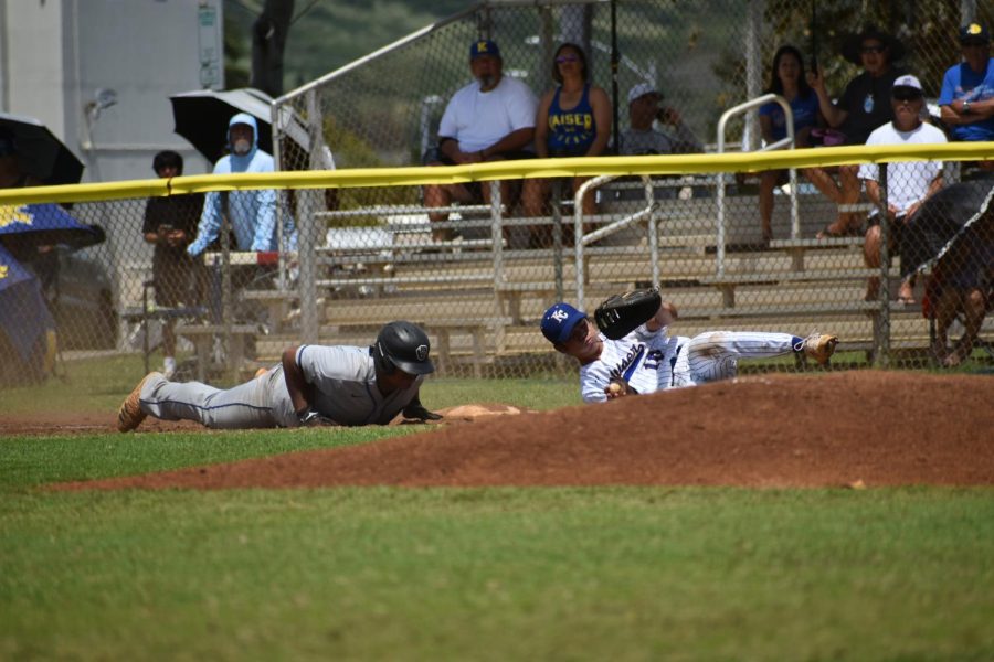 Colby Casinas dives into first base.