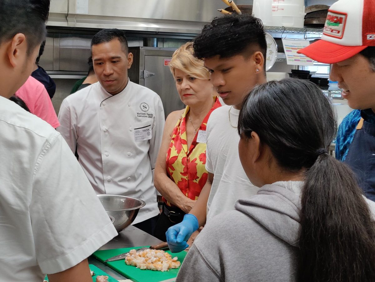 Executive Chef Matthew Naula from the Sheraton Hotel and Haley Matson-Mathes, executive director of the Hawaii Culinary Education Foundation, watch Adam Amian and the rest of his team prepare the shrimp and octopus appetizer.