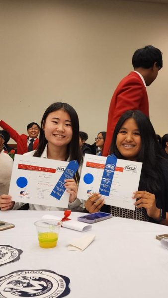 Kiara Watanabe (left) and Neveah Terrado hold up their blue ribbons for taking first in the knife skills competition at the recent CTSO convention.