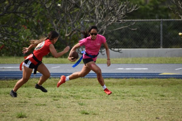Junior Marisa Lam is chased down by freshman Genna Fukumitsu in the annual powderpuff flag football game. The juniors ended up winning the game --and the championship title--8-0.