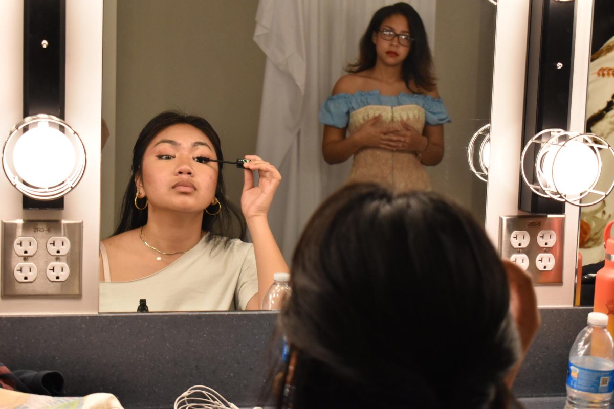 Marienne Mangayayam deftly applies mascara as she readies to play in the ensemble or take over as the understudy of Rosa Bud.