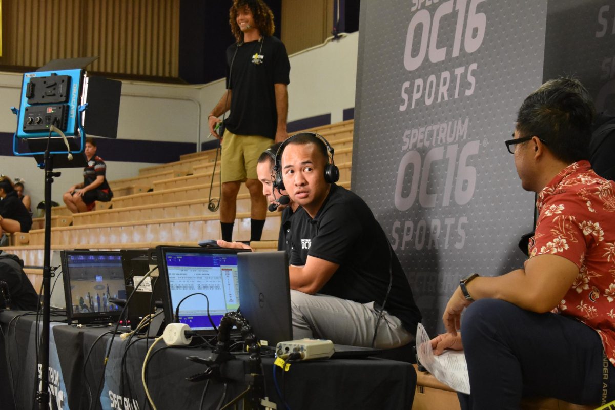 Felipe Ojastro gets instructions from his producer prior to the OIA boys basketball tournament at Pearl City High School.