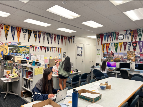 College and Career Counselor Courtney Chun (at desk) helps a student, while senior Kacie Arakaki, works on scholarships and college applications in the College and Career Center.
