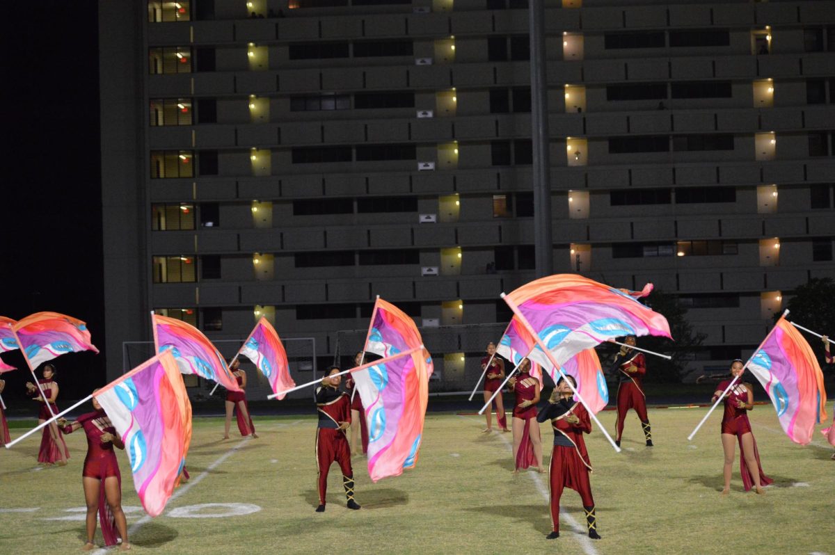 The Color Guard spin their flags to the Marching Band’s music.