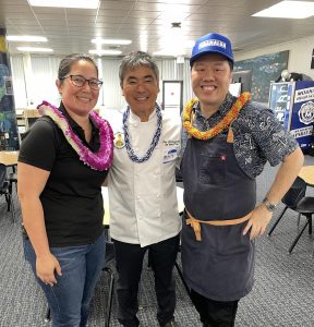Chef Roy Yamaguchi from Roy’s Waikiki poses with Baker Justine Perkins and Chef Lars Mitsuda for Culinary Event in MoHS Library
