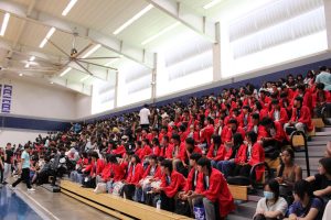 Kokutaiji (red coats) and Moanalua students gather in the gymnasium for Kokutaiji’s performance.
