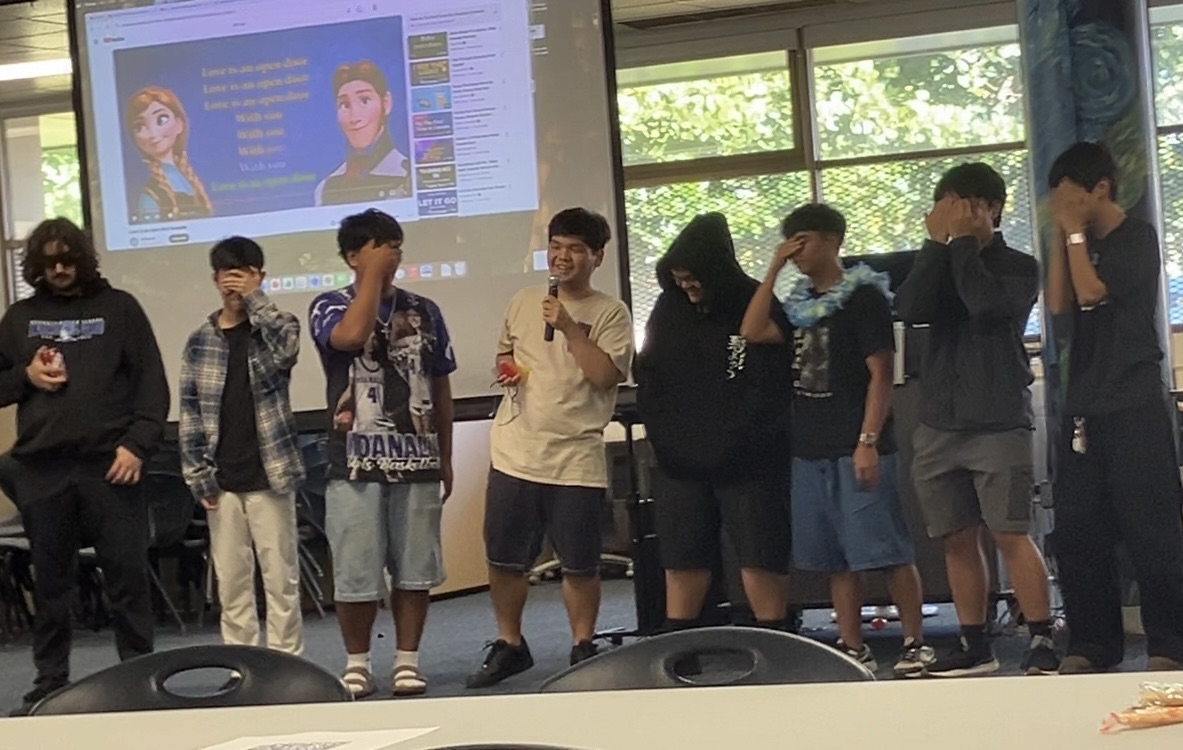 The senior boys of the Japanese Club line up to sing in blind karaoke in the Library.
